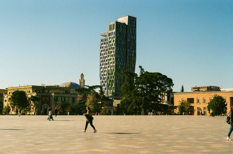 Start at Skanderbeg Square, Tirana’s lively main hub, surrounded by landmarks and summer events.